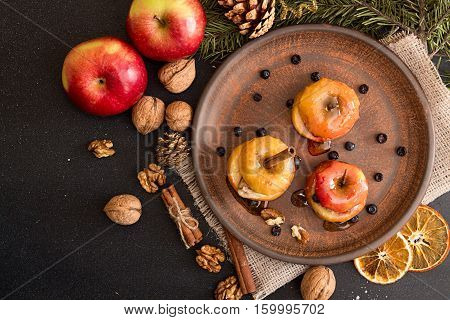 Baked Apples On Brown Plate With Holiday Christmas Decoration