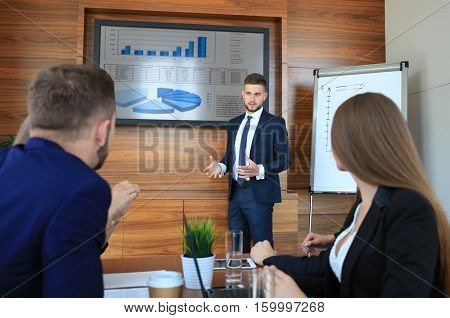 Business training at office business man presenting successful financial numbers on screen of plasma TV at meeting room