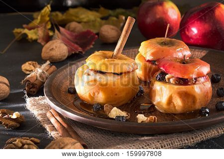 Baked Apples Stuffed With Walnuts And Honey On On Brown Plate