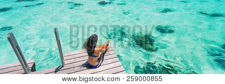 Luxury beach vacation travel destination woman relaxing on idyllic paradise blue turquoise clear water for snorkeling. Banner panorama with background texture on ocean.