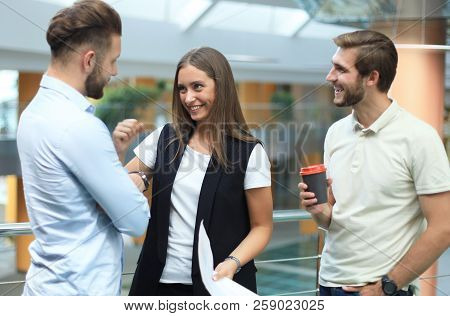 Group Of Young Modern People In Smart Casual Wear Having A Brainstorm Meeting While Standing In The 