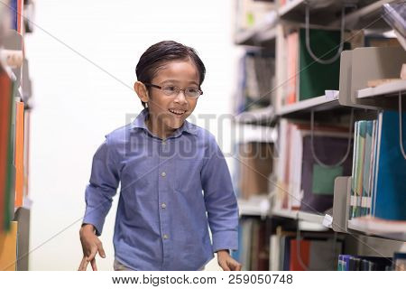 Happy Kids Lifestlye In The Library. Young People Explore Lifestlye In The Library. Boy Is Love To R