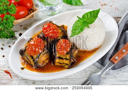 Meatballs Wrapped In Eggplant On A Plate Of Rice. Traditional Turkish Dish Islim Kebabi (kürdan Keba