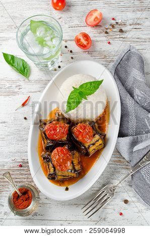 Meatballs Wrapped In Eggplant On A Plate Of Rice. Traditional Turkish Dish Islim Kebabi (kürdan Keba