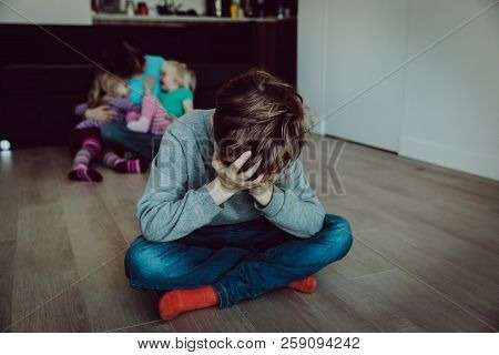 Family Rivalry-crying Sad Child And Mother Holding Other Kids