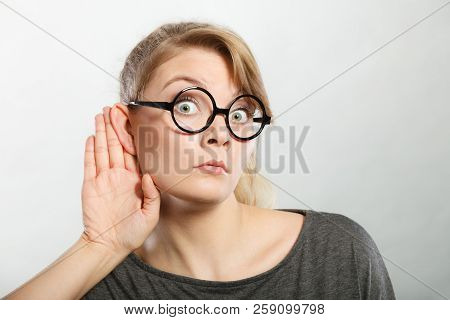 Hearing Gesture Shock Emotion Concept. Shocked Girl Eavesdropping. Young Nerdy Stunned Lady In Glass
