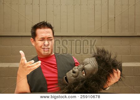 en mandlig model gør et ansigt på anmodning af fotografen til at bære hovedet Gorilla kostume