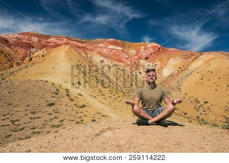 Relaxing man in Valley of Mars landscapes in the Altai Mountains, Kyzyl Chin, Siberia, Russia
