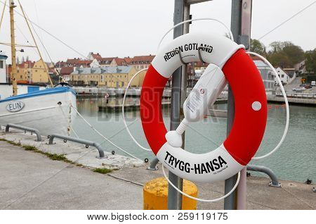 Visby, Sweden - May 15, 2016: One Red And White Lifebuoy A Symbol For The Insurance Company Trygg-ha