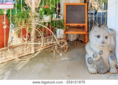 Gulangyu Island, China - September 14, 2013: Ornate Bicycle, Lucky Cat Maneki Neko And A Black Chalk