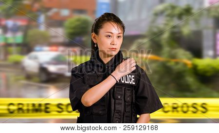 Asian American Woman Police Officer At Crime Scene