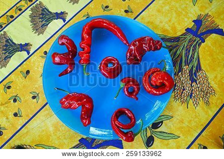 Eigth Red Hot Chili Peppers On A Blue Plate