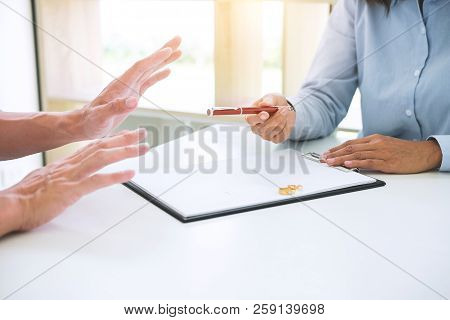 Husband And Wife Are Reading Divorce Agreement And Filing Pen To Signing Decree Of Divorce (dissolut