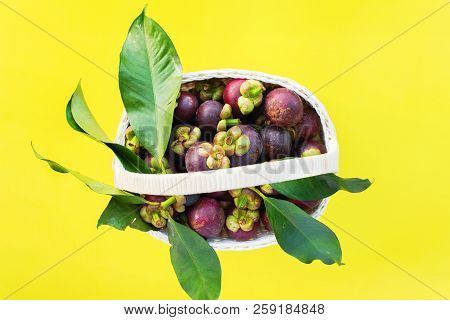 Mangostin With Leaves Tropical Fruits In White Basket On Yellow Background Raw Eating Concept Summer