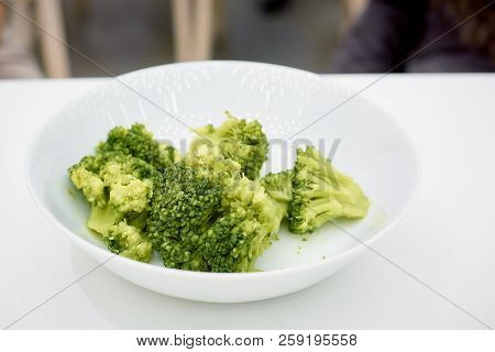 Branches Of Cabbage Of A Broccoli In Plate On A White Background