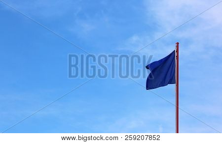 Blue Flag Waves On The Blue Sky With Few Clouds