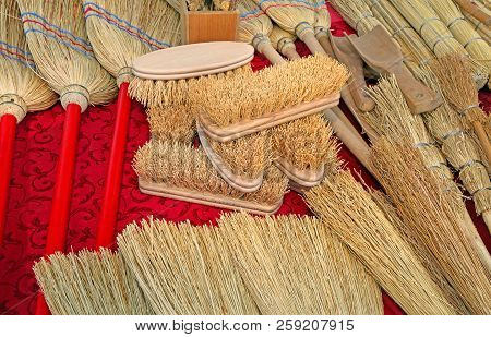 Many Brushes And Small Brooms In Sorghum For Sale At Market