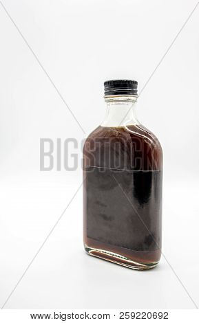Cold Brew Coffee In Glass Bottle With Black Cap Isolated On White