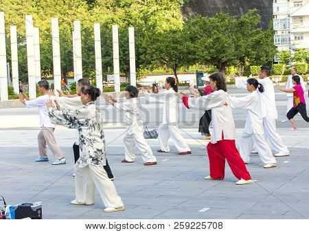 Sanya, China : 11 Nov 2017: Women And Men In The Street In The Park Gymnastics Wushu.