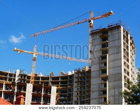 Construction Site Background. Two Cranes Near Building. Commerxial Building Proiect.