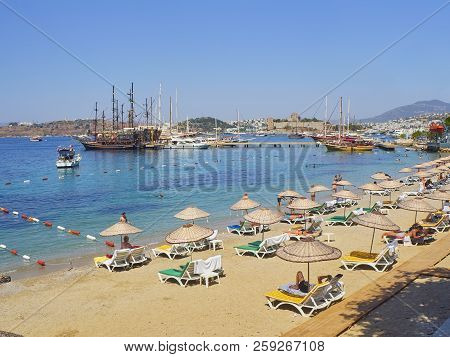 Bodrum, Turkey - July 5, 2018. Kumbahce Beach At Kumbahce Bay With Sailboats Moored At Bodrum Harbou
