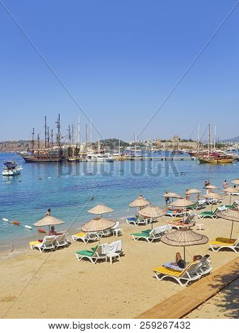 Bodrum, Turkey - July 5, 2018. Kumbahce Beach At Kumbahce Bay With Sailboats Moored At Bodrum Harbou