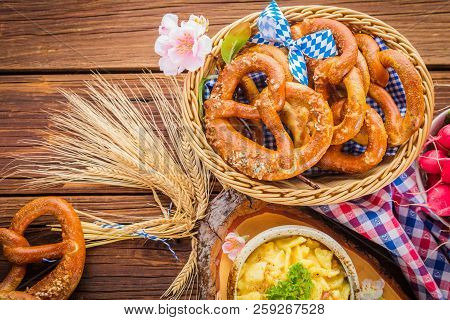 Oktoberfest Beer, Pretzels And Various Bavarian Specialties On Wooden Background