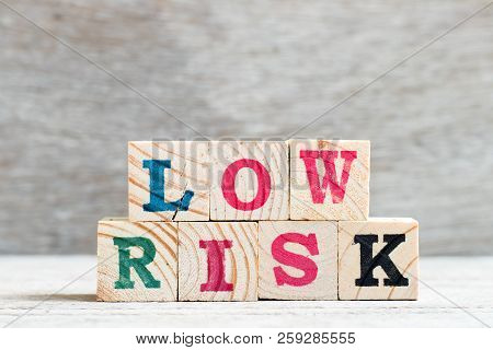 Letter Block In Word Low Risk On Wood Background