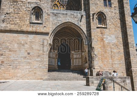 People Walk In Front Of The Cathedral Basilica Of Our Lady Of The Assumption Of Evora