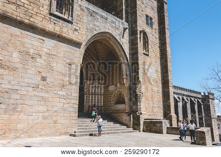 People Walk In Front Of The Cathedral Basilica Of Our Lady Of The Assumption Of Evora