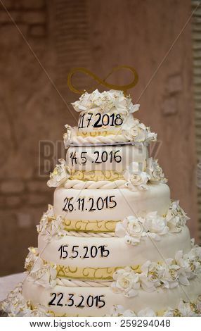 Genuine White Wedding Cake With Important Dates Of A Relationship Of Bride And Groom