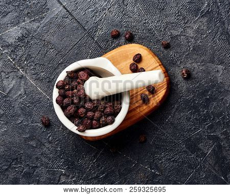 Dried Hawthorn Fruits On Black Background. Top View Of Crataegi Fructus.