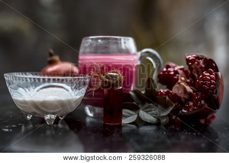 Close Up Of Pomegranate Shrbat Or Juice With Milk,pomegranate Essence,sugar And Raw Pomegranate On W