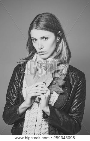 Woman With Autumn Leaves In Leather Jacket. Fashion Model With Stylish Hair In Scarf. Girl With Oran