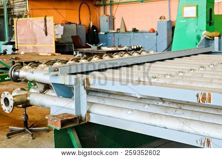 Warehouse, Storage Of Metal Iron Long Stainless Pipes With Flanges, Passages And Branches At The Pet