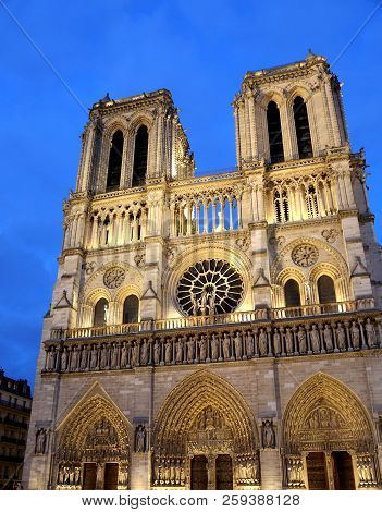 Basilica Of Notre Dame In Paris France By Night With Two High Bell Tower