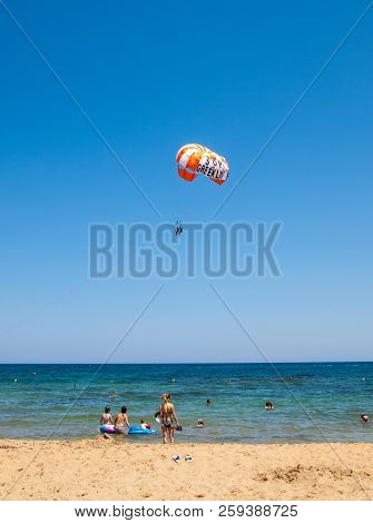 Malia. Crete, Greece - July 2, 2018:  Tourists On A Parachute Above The  Beach In Malia. Crete, Gree