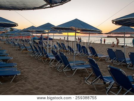 Malia. Crete, Greece - July 1, 2018: Sunbeds At The Beach In Malia On Crete, Greece