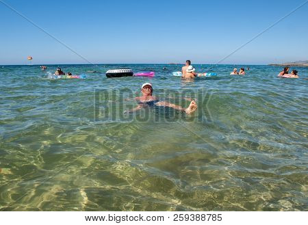 Malia. Crete, Greece - July 1, 2018: People Are Resting On A Sunny Day At The Beach In Malia, Crete,