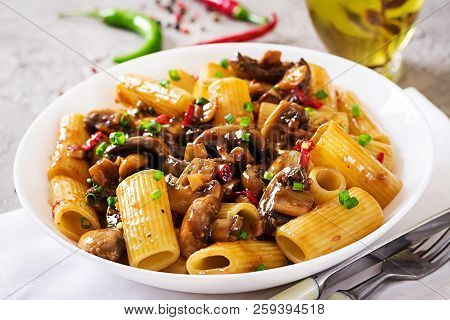 Vegetarian Pasta  Rigatoni With Mushrooms And Chilli Peppers In White Bowl On Grey Table. Vegan Food