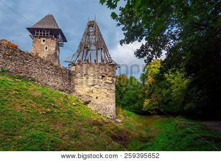 Two Towers Of Nevitsky Castle. Cloudy Autumn Weather. Some Yellow Foliage On The Trees