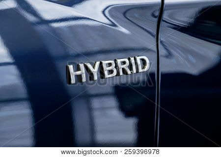 A Close-up Photograph Of The Inscription Hybrid On The Autobile Of Black Color.