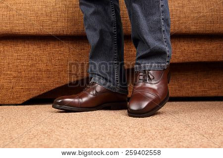 Men's Legs In Jeans Shod In Classic Brown Oxford Shoes