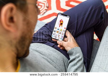 London, Uk - Sep 21, 2018: Man Using The New Yelling Chicken Ar Memoji Face Emoji On Apple Iphone Xs