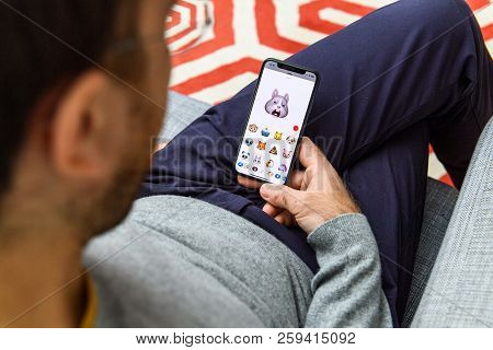 London, Uk - Sep 21, 2018: Man Using The New Sleeping Rabbit Ar Memoji Emoji Face On Apple Iphone Xs