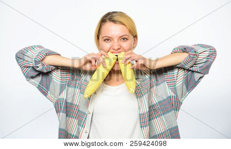 Girl Eating Uncooked And Unprocessed Food. Woman Farmer Eat Two Yellow Corn Cobs On White Background