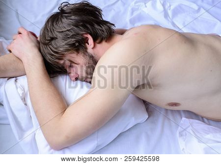 Let Your Body Feel Comfortable. Guy Nude Macho Lay White Bedclothes. Man Sleepy Drowsy Unshaven Bear