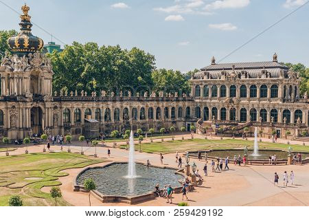 Dresden, Germany - July 24, 2018: People Walking Near Fountains And Beautiful Architecture Of Ancien