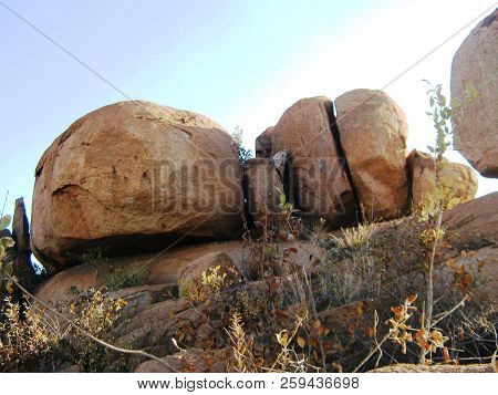 Round And Split Rocks On Flat Rock Surface