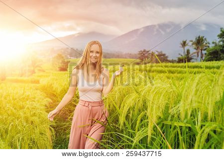 Young Woman Traveler On Beautiful Jatiluwih Rice Terraces Against The Background Of Famous Volcanoes